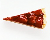 A piece of strawberry tart with jelly and flaked almonds