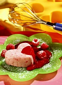 Semolina pudding, raspberry sauce, icing sugar (bleeding hearts)