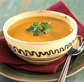 Carrot soup with coriander in a bowl