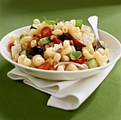 Pasta salad with vegetables, pine nuts and basil