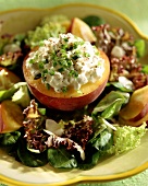 Peach stuffed with cottage cheese on mixed salad leaves