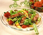Green salad with beef and strawberries