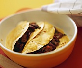 Tortillas with beef and beans in a baking dish