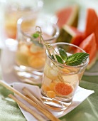 Melon drinks with fresh mint; grissini