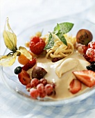 Semolina halva with berries, physalis & mint leaf on plate