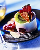 Mousse with summer fruits on blue plate