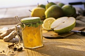 Pear jam with ginger and cinnamon in jar; ingredients