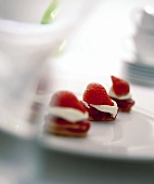 Mini-tartlets with strawberries and cream on a plate