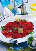 Beef carpaccio with lemon slices and chervil