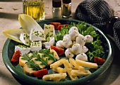 Cheese platter with tomatoes, salad and chives