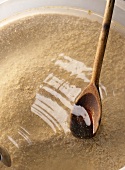 Starter mash with wooden kitchen spoon