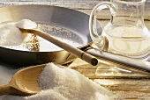 Sugar on scoop & in pan (ingredients for caramel)