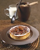 Small pecan & honey cake with icing sugar on plate