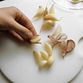 Peeling cloves of garlic