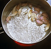 Frying cloves of garlic in hot fat