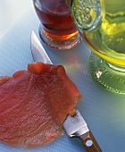 Cutting tuna into thin slices
