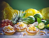 Lime tartlets with pineapple, slivered almonds & coconut