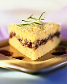 A piece of polenta cake with onion filling and rosemary