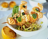 Shrimp and salmon kebabs with courgettes on bowl of sprouts