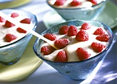 Mascarpone mousse with fresh raspberries in blue bowls