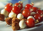 Kebab with mince, quail's eggs and cherry tomatoes