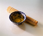 Soya oil in Chinese bowl beside bast mat