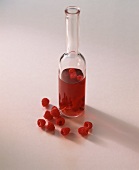 A bottle of raspberry vinegar and a few raspberries