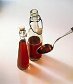 Red wine vinegar in bottles and on spoon