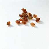 Several raisins on white background