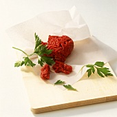 Mince and parsley with paper on chopping board