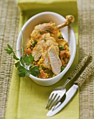 Chicken with saffron rice and parsley in a baking dish