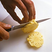 Slicing baby pineapple