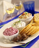 Three different dips with crackers
