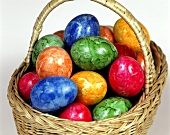 Coloured eggs in basket