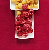 Yellow and red raspberries in punnets