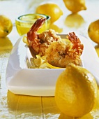 Deep-fried citrus shrimps; fresh lemons beside them
