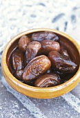 Dates in brown earthenware dish