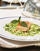 Salmon fillet on peas with fresh mint