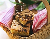 Crumble cake on checked cloth in basket