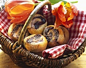 Coiled buns with plum puree in basket; tulips