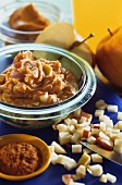 Apple, raisin and peanut butter spread in glass bowl
