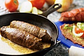 Beef roulades in frying pan; ingredients