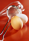 Eggs with sieve and whisk