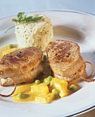 Pork fillets with rice and pineapple and pea sauce