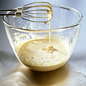 Beating egg yolk with sugar until thick and creamy