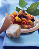 Aubergine and pepper stew with white bread; bay leaves