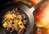 Fried mince with vegetables in frying pan