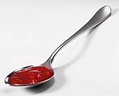 Chunky tomato sauce on spoon