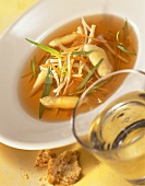 Consomme with asparagus, strips of vegetable & fresh tarragon