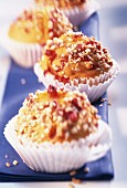 Pumpkin and cranberry muffins with nuts in paper cases